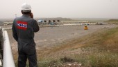 Larry Morrow, a construction supervisor for Norway's DNO Iraq, taking a call about work at the Tawke field as he overlooks the crude processing facility at DNO's Feyshkabour export center. On the far right is where Tawke field oil is piped in. To the left, pipelines running from a tanker offloading center where other KRG fields truck their crude to be exported. (BEN LANDO/Iraq Oil Report)