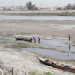 Iraqi men move a boat that was stuck on the banks of the Euphrates river in Twairij, roughly 20 kilometers east of Karbala, due to a decline in the water level after supplies were blocked by anti-government fighters who control access to the Fallujah dam further upstream in conflict-hit Anbar province on April 8, 2014. (MOHAMMED SAWAF/AFP/Getty Images)