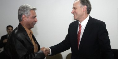 Vierbuchen, president of ExxonMobil Upstream Ventures, shakes hands with al-Ameedi, deputy director-general at PCLD, after signing a deal in Baghdad