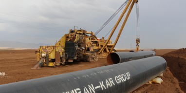 Pipe-laying machine stands beside sections of 36" diameter steel pipe, which await welding next to a trench dug 5 km west of the town of Sumel in Dohuk province. (PATRICK OSGOOD/Iraq Oil Report)