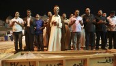 Mourners pray over the coffin of a victim killed in one of Monday's bomb attacks, during a funeral in Najaf